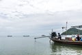 Thai traditional longtail boat tour big diesel engine in action smoke pollution