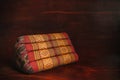 Thai traditional old vintage triangle pillow on wood background Royalty Free Stock Photo