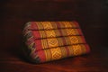 Thai traditional old vintage triangle pillow on wood background Royalty Free Stock Photo