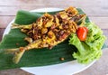 Thai Traditional Style Fried Fishes with Herbs like Turmeric and Garlic Served on Banana Leaf with Tomato and Cabbage. Healthy Foo