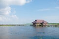 Thai traditional teak wood village in blue calm lake Royalty Free Stock Photo