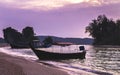 Thai traditional wooden longtail boats at the purple sunset in Krabi province. Thailand. Royalty Free Stock Photo