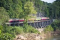 Thai trains running on death railways crossing kwai river in Kanchanaburi