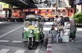 A Thai tuk-tuk tricycle waits to pick up customers beside the railway line at Bang Son Market, Bangkok