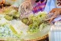 Thai vendor is selling shredded rice grain dessert to the custom