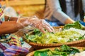 Thai vendor is selling shredded rice grain dessert to the custom