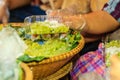 Thai vendor is selling shredded rice grain dessert to the custom