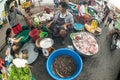Thai vendors sell fresh fish for cooking in a morning market.