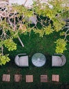 Thai vintage outdoor rattan chairs and glass table on glass lawn under tree Royalty Free Stock Photo