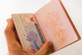 Thai visa stamp in russian passport in mens hand