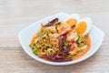 Thai wing bean salad with fresh coconut milk shrimp served with boiled eggs is a delicious Thai food style while put on a wooden