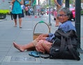 Thai woman beggar sitting on the sidewalk