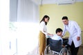 Thai woman is Caring and Take the old father sitting on wheelchair and illness health for to see a doctor Royalty Free Stock Photo