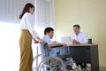 Thai woman is Caring and Take the old father sitting on wheelchair and illness health for to see a doctor Royalty Free Stock Photo