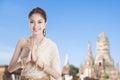 Thai woman in Thai dress costume traditional in a welcome pose