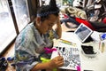 Thai woman people painting natural color indigo on fabric on table