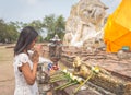 Thai woman praying in Ayutthaya temple in front the big buddha. Royalty Free Stock Photo