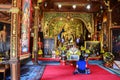 Thai woman praying Golden Buddha at Wat Ming Mueang