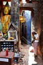 Thai woman praying ruins buddha statue image at Vat Phou or Wat Phu