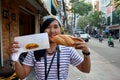 Thai woman show french loaf or baguette sandwich