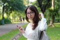 Thai woman student university beautiful girl using her smart phone. Royalty Free Stock Photo