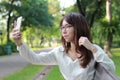 Thai woman student university beautiful girl using her smart phone. Royalty Free Stock Photo