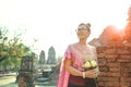 Thai woman toothy smiling face standing with pink lotus flower b Royalty Free Stock Photo