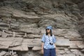 Thai women travel and posing at Rock art on cliffs at Pha Taem National Park in Ubon Ratchathani, Thailand Royalty Free Stock Photo