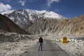 Thai woman visit and pose portrait for take photo with Milestone on Pangong lake road at Leh Ladakh in Jammu and Kashmir, India
