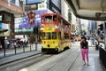 Thai woman walking go to bus station for passenger retro and vintage tram in Hong Kong, China Royalty Free Stock Photo