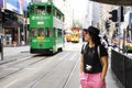 Thai woman walking go to bus station for passenger retro and vintage tram in Hong Kong, China Royalty Free Stock Photo