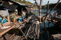 Thai woman wash her clothes on a wood raft river