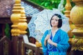 Thai woman wearing typical Thailand traditional dress at house (