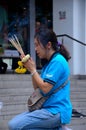 Thai woman worships and prays at outdoor shrine Bangkok Thailand