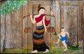 Thai women and child painting at window
