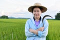 Thai women farmer with sickle in hand