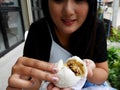 Thai women holding and show Kind of Chinese snacks steamed stuff buns before eat at outdoor of cafe and local restaurant Royalty Free Stock Photo