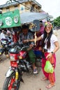 Thai women pay carfare to driver of tricycle