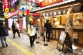 Thai women and people stand waiting line up for buy food Taiyaki or Japanese fish-shaped cake from local shop in Tokyo, Japan