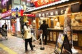 Thai women and people stand waiting line up for buy food Taiyaki or Japanese fish-shaped cake from local shop in Tokyo, Japan