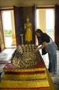 Thai women people visit and respect praying Buddha`s footprints