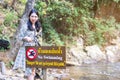 Thai women point to forbidden to swim sign in this area contradiction