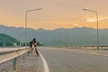 Thai women ride bicycle for exercise in the evening after sunset at Sriganarind Dam,