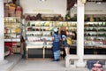 Thai women select and buy holy amulet and jade accessory form talismans souvenir shop of Kaiyuan Temple at Teochew in Guangdong