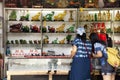 Thai women select and buy holy amulet and jade accessory form talismans souvenir shop of Kaiyuan Temple at Teochew in Guangdong