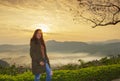 Thai women sit viewpoint beautiful sunshine at misty morning mountains ,Phulangka National Park, Payao Province,thailand