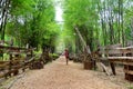 Thai women travel and posing for portrait on walkway crushed stone with bamboo cave at the National Ethnic Cultural Park Royalty Free Stock Photo