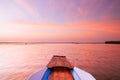 Thai wooden boat bow travel in peaceful blue Nong Harn lake - Udonthani, Thailand. Famous red lotus lake in winter Royalty Free Stock Photo