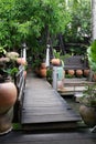 Thai wooden bridge walk way over canal or ditch to enter old sty Royalty Free Stock Photo