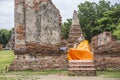 Thai word in blue sign written mean `saiyayan buddha` a big sleeping buddha cover by orange clothe in an ancient ruins chapel
